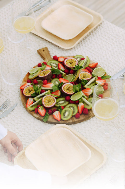 Fruit pizza for serving on disposable ChicLeaf palm leaf plates.